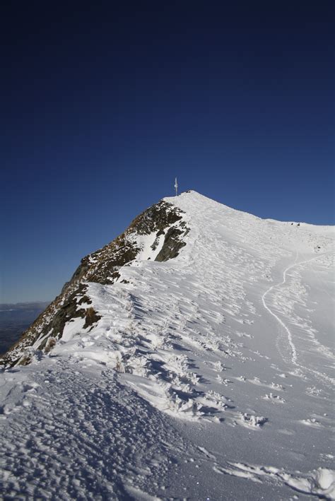 Walking on a snow covered mountain peak free image download