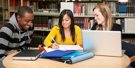 College students studying in a library of books – Library Research Service