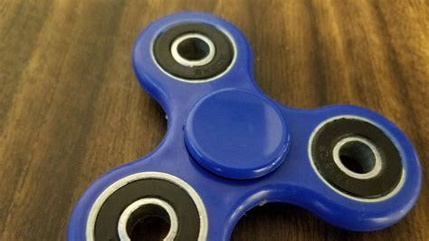 Download Fidget Toy On Wooden Table Wallpaper | Wallpapers.com