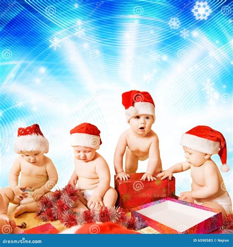 Toddlers in Christmas hats stock image. Image of gift - 6590583