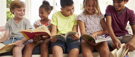 Group Of Multi-Cultural Children Reading On Window Seat | Laura Candler