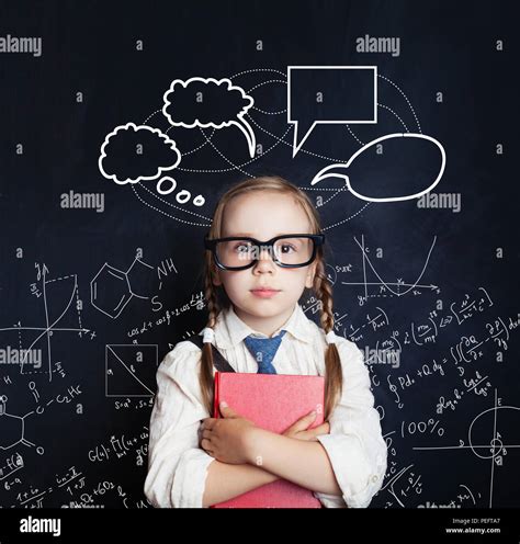 Tired little girl student on blackboard background with science hand drawings pattern and speech ...