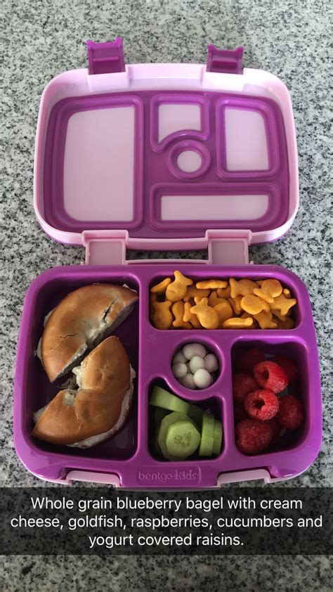 a purple lunch box filled with different types of food and text that ...