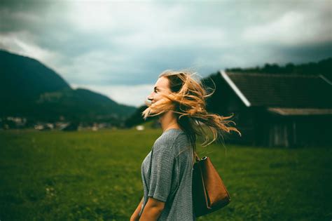 Woman Carrying Brown Leather Bag on Grass Field · Free Stock Photo