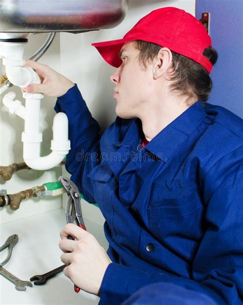 Plumber in uniform stock image. Image of pliers, smile - 29235113