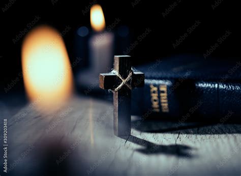 Holy Bible and wooden cross on dark background Stock Photo | Adobe Stock