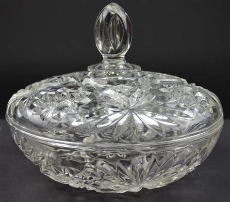 an ornate glass bowl with a lid