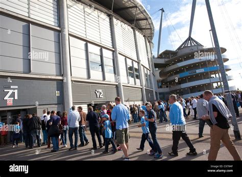 Fans queue outside the Etihad Stadium, Manchester City Football Club, Manchester, England ...