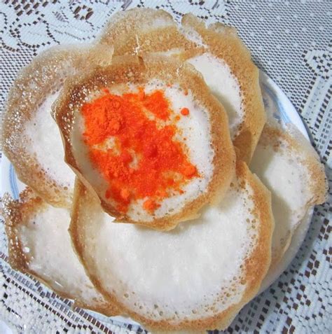 Apom is an Indian style breakfast made from rice flour and eaten with curry, eggs, cheese, syrup ...