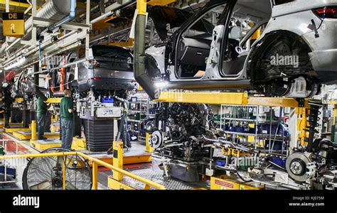 Workers on engine production line in car factory Stock Photo - Alamy