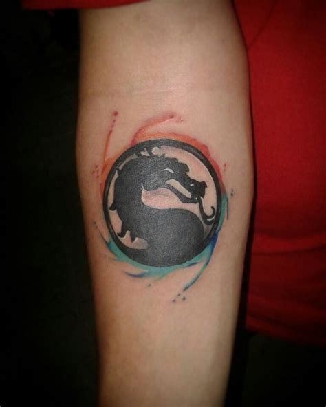 a woman's arm with a tattoo on it that has a black and blue dragon in the center