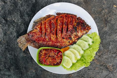 Delicious grilled tilapia from indonesia with rice, tempeh, vegetables ...