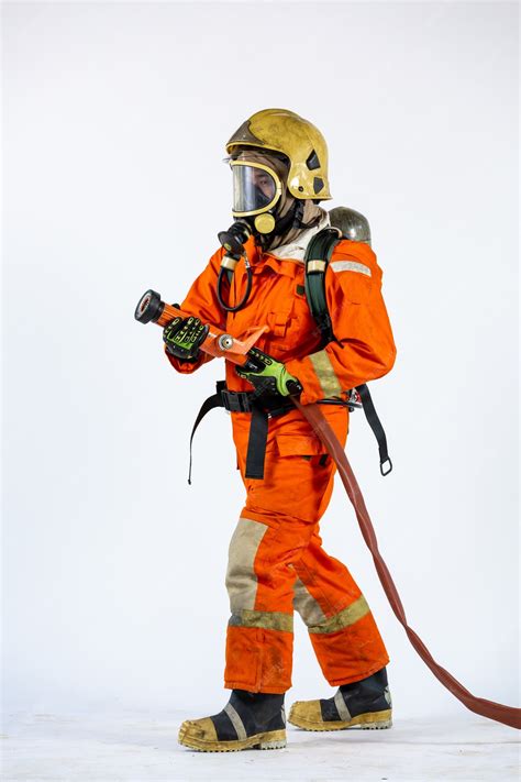 Premium Photo | Firefighter with axe in hands uniform and hardhat ...