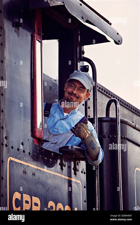 friendly train engineer heritage park Stock Photo - Alamy