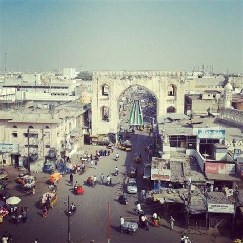 an aerial view of a city street with people and vehicles