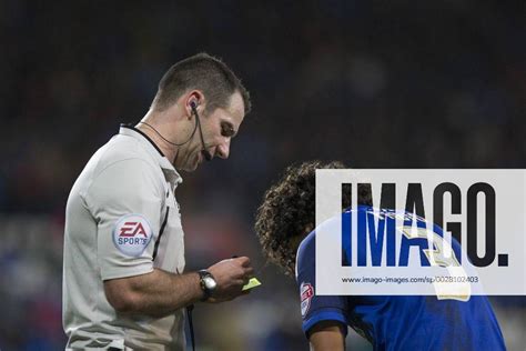 Referee Tim Robinson gives a yellow card to Fabio Da Silva of Cardiff ...