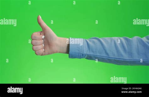 Thumbs up sign hand gesture on green screen. Simbol of approval like ...