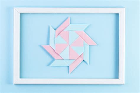 Premium Photo | Origami star. made with square sheets of paper and white wood frame.