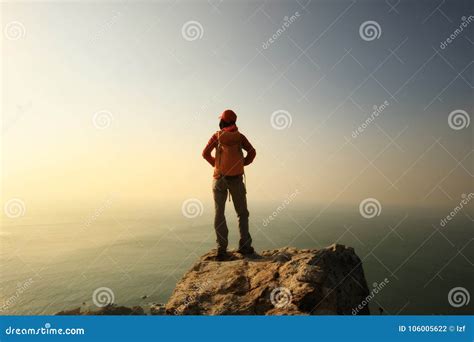 Hiker Stand on the Cliff Edge at Sunrise Seaside Stock Photo - Image of ...