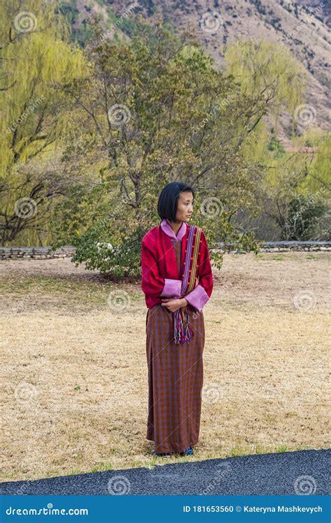 Bhutanese Boy And Girl Both In Traditional Clothes Stand Beside The Stairs , Bhutan Editorial ...