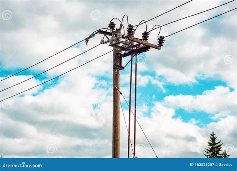 A Wooden Powerline Pole With The Powerline Coming Into The Ground And ...