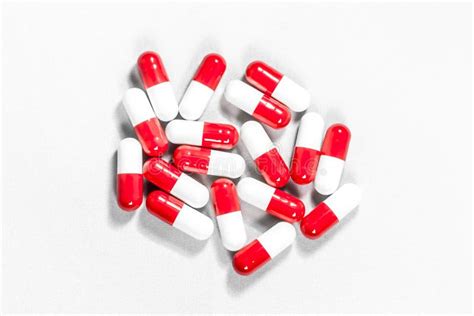 Red and white pills stock image. Image of dosage, medication - 104551563