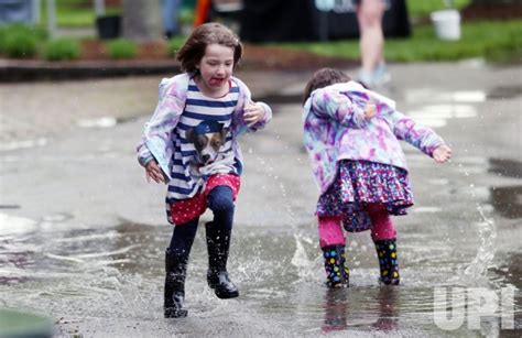 Photo: Children play in rain puddles - SLP2019042722 - UPI.com