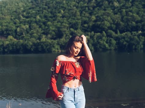 Woman wearing off-shoulder crop top while holding her hair photo – Free Prishtina Image on Unsplash