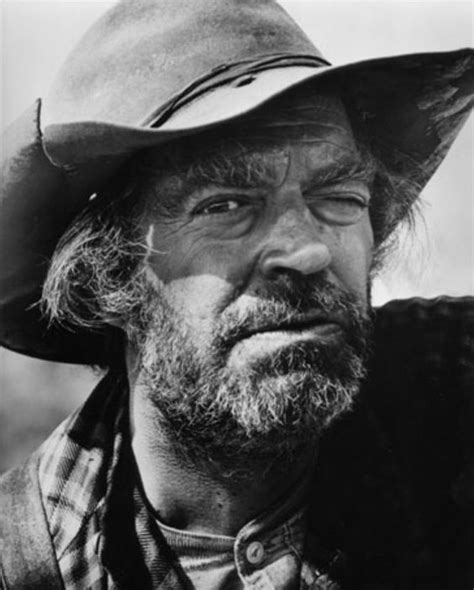 an old photo of a man wearing a cowboy hat and looking off to the side