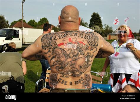 A man displaying his England Tattoo which covers his back and shows St ...