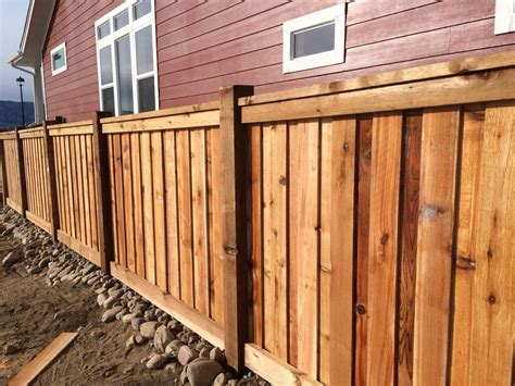 Custom cedar wood fence with 6x6 posts, 6" overlapping pickets, 2x4 top cap and fascia and 2x6 ...