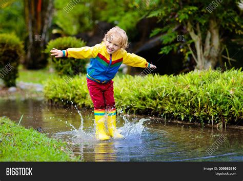 Child Playing Puddle. Image & Photo (Free Trial) | Bigstock