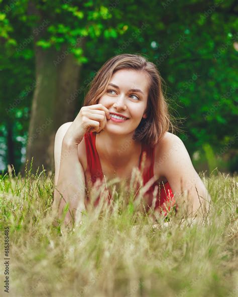 beautiful girl lying down of grass Stock Photo | Adobe Stock