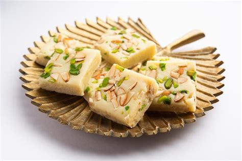 Premium Photo | Milk powder barfi also known as Mava burfi white Khoya burfi or Barfee Indian ...