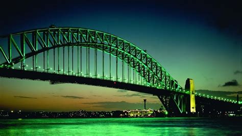 the green bridge is lit up at night