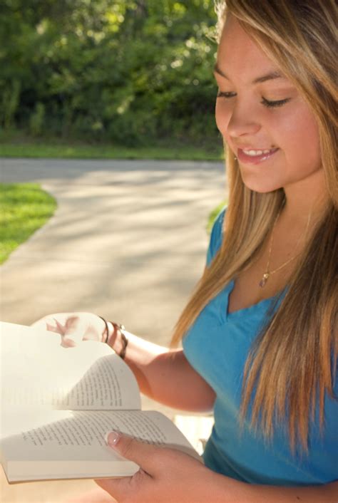 Reading | Free Stock Photo | A young woman reading a book outdoors | # 16094