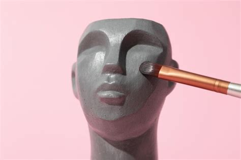 Premium Photo | Decorative head with makeup brush on pink background