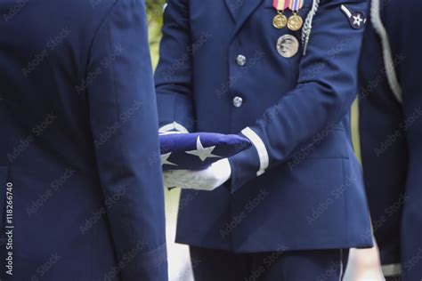 Soldiers folding flag at military funeral Stock Photo | Adobe Stock