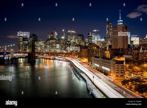 Cityscape at night of Lower Manhattan Financial District with illuminated skyscrapers and World ...