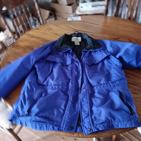 LADIES EDDIE BAUER WINTER COAT AND LIGHT JACKETS, ARIAT BOOTS AND WOODEN COAT RACK | EstateSales.org