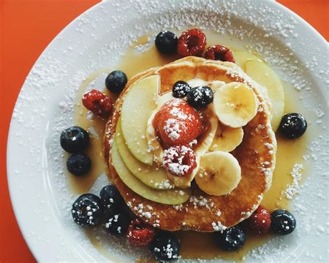 Premium Photo | Pancakes with fresh fruit and maple syrup