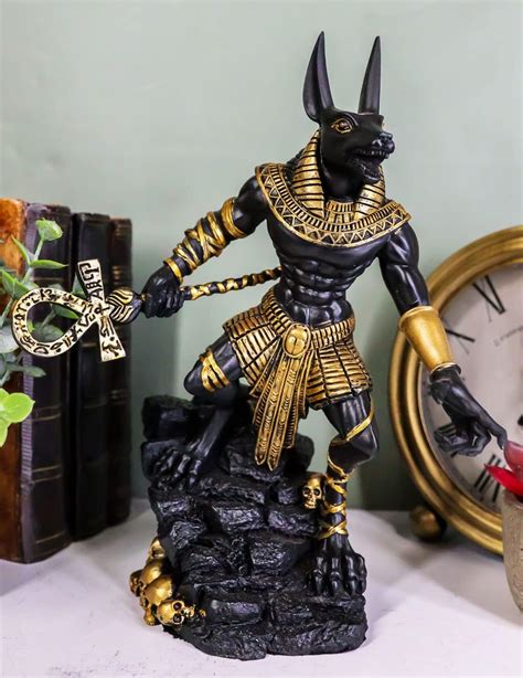 Buy Ebros Ancient Egyptian Jackal God Anubis with Ankh Staff Spear Standing On Rocky Skulls Heap ...