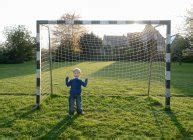 Boy cheering in goal on the football field — sunlight, standing - Stock Photo | #172008672