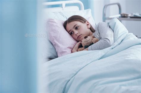 Sick girl in hospital bed Stock Photo by bialasiewicz | PhotoDune