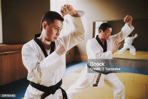 Two Martial Arts Students In White Keikogi Doing Karate Stances Stock ...