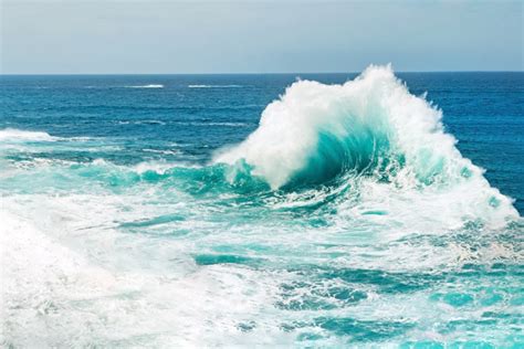 What is a backwash wave and how does it form?