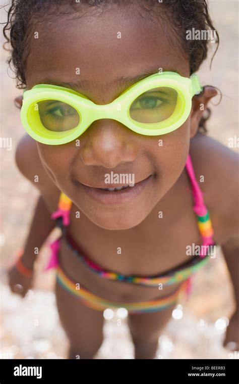 Smiling African girl wearing goggles and bikini Stock Photo - Alamy