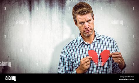 Composite image of sad man with broken heart Stock Photo - Alamy