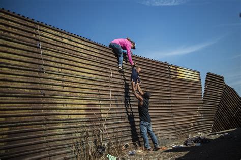 Migrants trying to hop border fence hit with tear gas - The Boston Globe