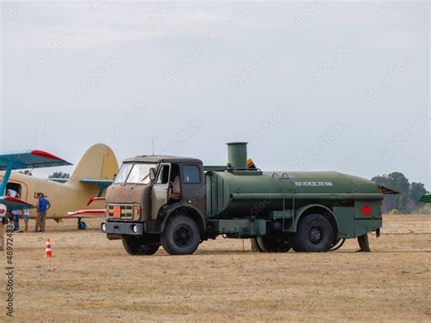 Fuel tanker refuels aircraft at the airport Stock Photo | Adobe Stock